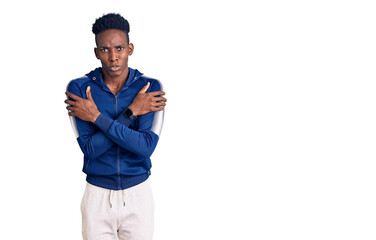 Young african american man wearing sportswear shaking and freezing for winter cold with sad and shock expression on face