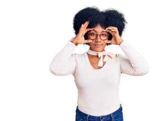 Young african american girl wearing casual clothes and glasses trying to open eyes with fingers,...