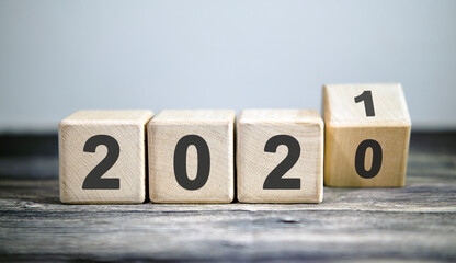 Wooden blocks for change year 2020 to 2021 . New year and holiday concept.