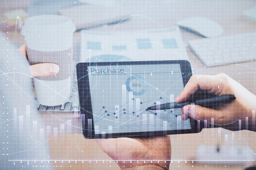 Double exposure of man's hands holding and using a phone and financial chart drawing. Market analysis concept.