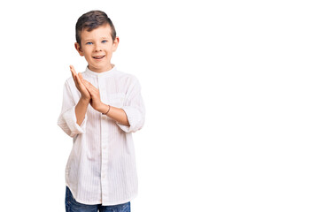 Cute blond kid wearing elegant shirt clapping and applauding happy and joyful, smiling proud hands...
