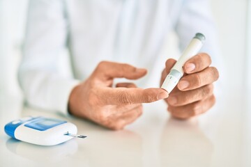 Close up of man with diabetes using insuline stick with syringe - obrazy, fototapety, plakaty