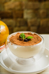 Fresh dessert with cocoa in a transparent bowl.