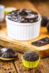 Brigadeiro ou negrinho, typical candy for children's birthday parties in brazil, punctual focus, on rustic table