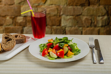 Summer fresh salad of tomato cucumber leaves lettuce.