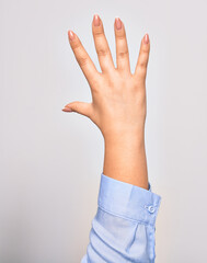 Hand of caucasian young woman showing number five with opened palm and streched fingers raised up over isolated white background