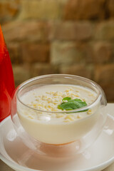 Fresh dessert with white chocolate in a transparent bowl.