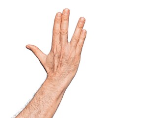 Hand of caucasian middle age man over isolated white background greeting doing Vulcan salute, showing back of the hand and fingers, freak culture