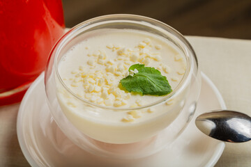 Fresh dessert with white chocolate in a transparent bowl.