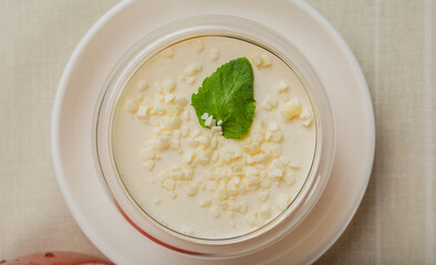 Fresh dessert with white chocolate in a transparent bowl.