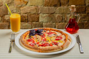 Fresh hot pizza on white plate in restaurant.