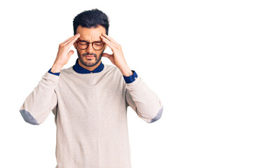 Fototapeta premium Young handsome hispanic man wearing elegant clothes and glasses with hand on head for pain in head because stress. suffering migraine.