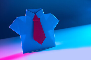 Business concept. Symbolic origami figure of an entrepreneur. Origami businessman. Origami shirt and tie. Business style in clothing.