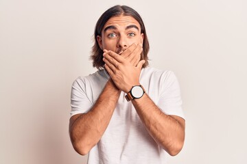 Young handsome man wearing casual clothes shocked covering mouth with hands for mistake. secret concept.