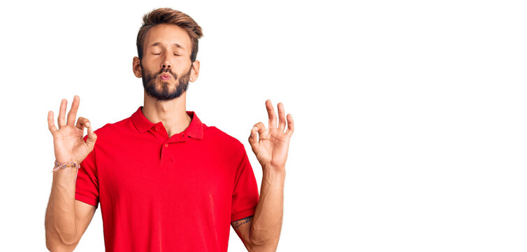 Handsome blond man with beard wearing casual clothes relax and smiling with eyes closed doing meditation gesture with fingers. yoga concept.