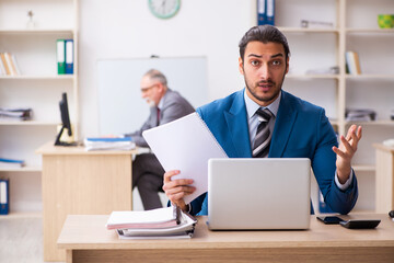 Two male colleagues working in the office