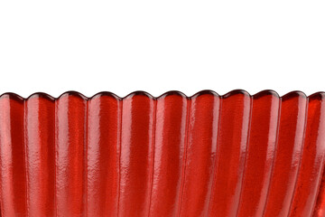 macro photo of red glass isolated on white background, close-up view of beautiful wavy edge glass, abstract background