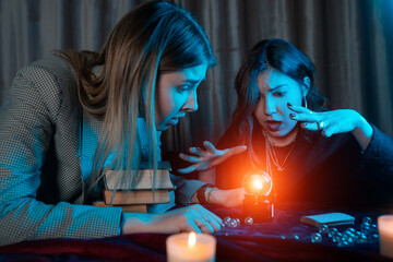 Woman and woman fortune teller with crystal ball