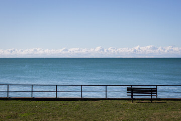 Fototapeta na wymiar bench and railing over open water