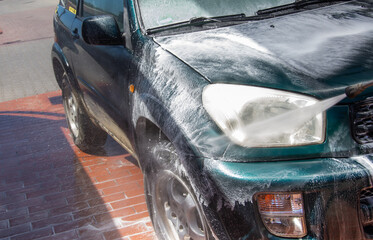 High pressure washing car outdoors