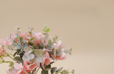 artificial branches of flowers on beige monochromatic background