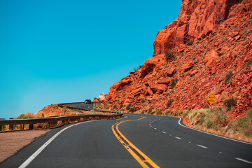 Road against the high orange rocks. Summer highway road.