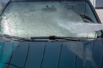 High-pressure washing car outdoors