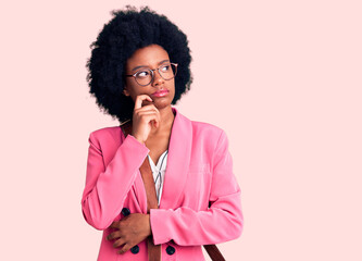 Young african american woman wearing business clothes and leather bag serious face thinking about...