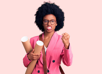 Young african american woman holding architect blueprints annoyed and frustrated shouting with anger, yelling crazy with anger and hand raised