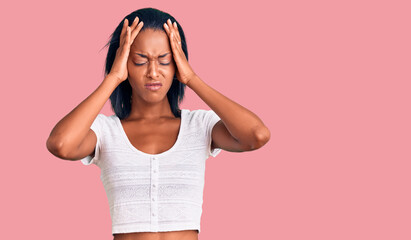 Young african american woman wearing casual clothes suffering from headache desperate and stressed because pain and migraine. hands on head.