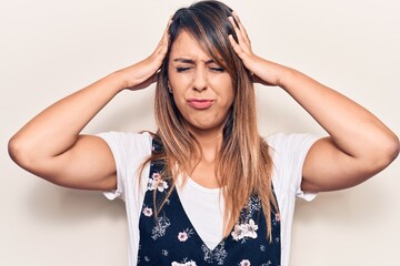 Obraz premium Young beautiful woman wearing casual floral dress with hand on head, headache because stress. suffering migraine.
