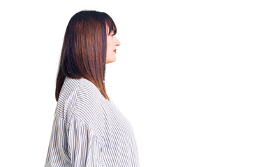 Young plus size woman wearing casual clothes looking to side, relax profile pose with natural face...