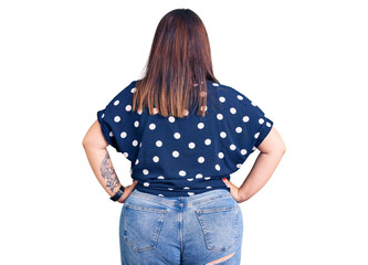 Young plus size woman wearing casual clothes standing backwards looking away with arms on body