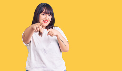 Young plus size woman wearing casual clothes pointing to you and the camera with fingers, smiling positive and cheerful