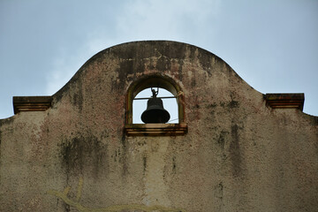 Lone church bell hanging on the top