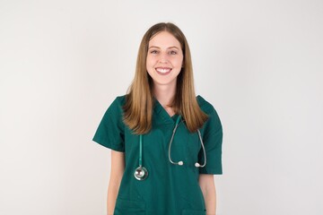 Female doctor wearing a green scrubs and stethoscope with a happy and cool smile on face. Lucky person.