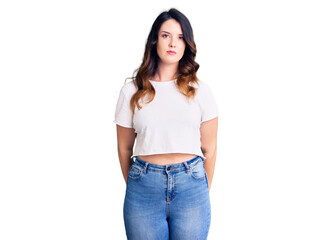 Obraz premium Beautiful young brunette woman wearing casual clothes with serious expression on face. simple and natural looking at the camera.