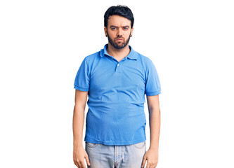Fototapeta premium Young hispanic man wearing casual clothes depressed and worry for distress, crying angry and afraid. sad expression.