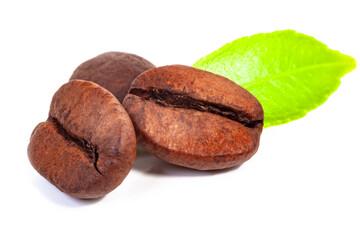 three roasted coffee beans and a green leaf on a white background, isolate