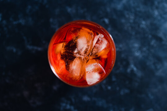 Refreshing Red Spritz Cocktail With Ice On Dark Background