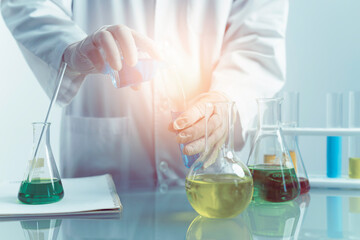 Dropping chemical liquid to test tube, laboratory research and development concept. scientist...