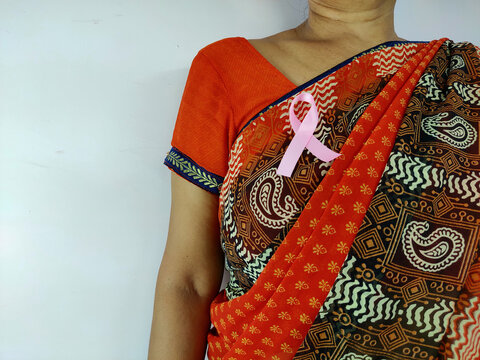 Pink bedge on indian women breast for awareness , space for text on white background