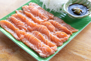  fresh slices salmon fillet on plate to make Salmon Sashimi