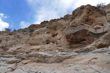 Large stony outcrop jutting out of sandstone cliff