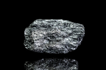 Manganese ore, raw rock on black background, mining and geology