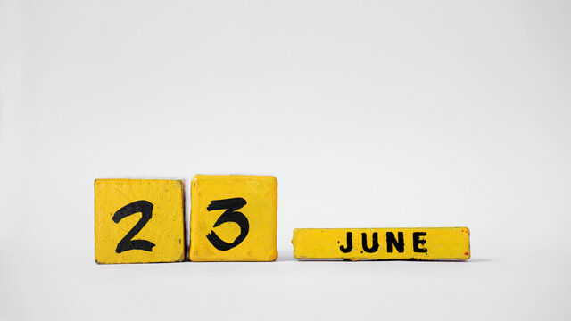 JUNE 23 Wooden calendar. International Widows' Day. United Nations Public Service Day. White background with space for your text