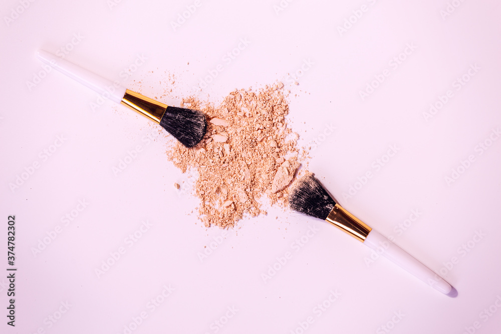 Wall mural make up brushes with powder on white background