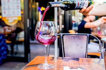 fancy elegant cafe restaurant red wine pouring waiter