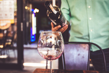 red wine pouring waiter service in a coffee restaurant