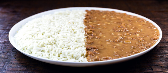 rice with beans, typical Brazilian meal, on a white plate. Vegan food